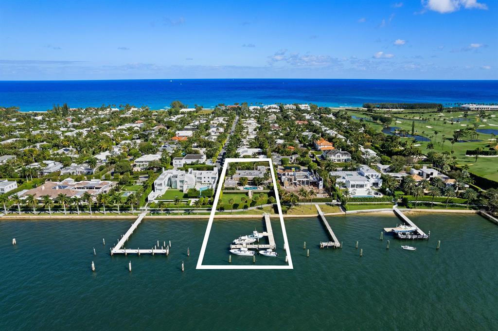 Magnificent Lake Front Regency situated on high elevation with amazing panoramic views!! Deep water concrete dock which can accommodate up to a 130' yacht and includes a 40k lb lift and a 15k lb lift for smaller boats. Private deeded beach access! Spacious floor plan features high ceilings, 5 bedrooms, 6.5 baths, 2 kitchens, 2 offices, media room, billiards room, 4 bars, several water features inside and outside, Gas fireplace, oversized travertine pool terrace and covered loggias perfect for entertaining!!