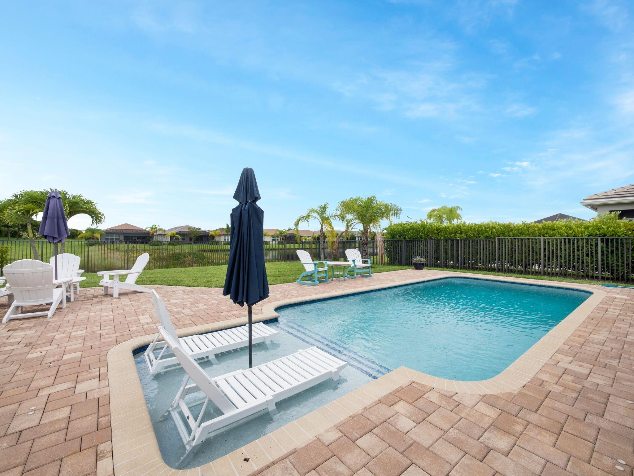 Live the dream in this stunning lakefront pool home, perfectly situated on an oversized corner lot in the highly sought-after Valencia Cay at Riverland! This beautifully upgraded 4-bedroom, 2.5-bath residence features soaring ceilings in the primary bedroom and main living area, enhancing the bright and open feel throughout. The gourmet kitchen is a chef's delight, boasting an upgraded gas range, stainless steel refrigerator, designer tile backsplash, and a spacious island ideal for entertaining. The luxurious primary suite offers peaceful lake views and a spa-style bathroom with upgraded shower doors. Step outside to your private backyard oasis featuring an extended screened patio, sparkling pool, and plenty of space to relax or entertain.