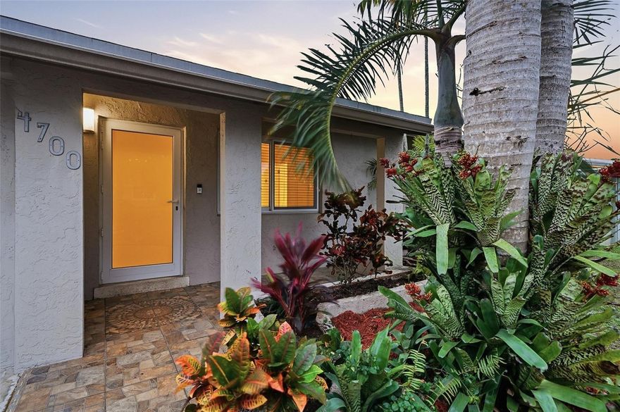 Beautiful 3 bedroom pool home designed for effortless entertaining. Amazing pool with LED lighting, set against a marble-paver patio surrounded by lush, mature tropical palms for a private, resort-style feel. The front living room features a charming coffered ceiling, while expansive dining and entertainment spaces open to the pool through sliding glass doors. Additional highlights include hurricane-impact windows and doors, a spacious primary suite with an updated bath, a full-size washer and dryer, and a kitchen with stainless appliances. Conveniently located near the beach, Wilton Manors, I-95, and the airport.