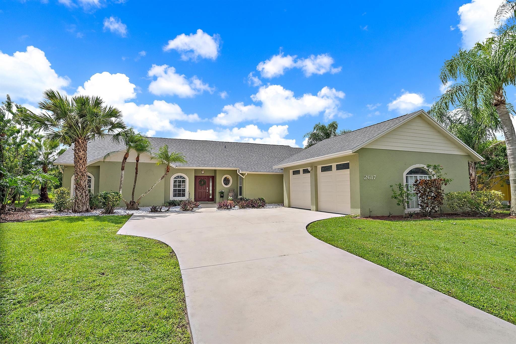Stunning Waterfront Pool Home in Gated Palm Lake Gardens - Enjoy panoramic lake views from this beautifully maintained 4BR/3BA home with a 2020 roof and driveway, 2021 A/C, and new carpet. The spacious layout includes a large primary suite with walk-in closet, dual vanities, soaking tub, and separate shower. Entertain in style with formal dining, an eat-in kitchen, and custom built-in bar. Step outside to a screened-in pool and patio overlooking serene water views. Additional features include a 2-car garage and ample storage - modern living at its finest! Furniture negotiable.