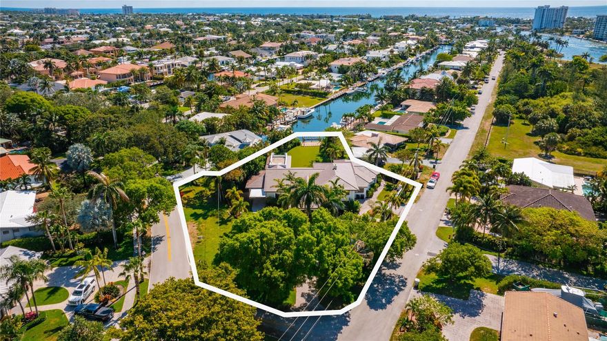 Huge 21,832 square foot lot within minutes of the Hillsboro Inlet!  Located in South Lighthouse Point this gated estate with porte cochere boasts a stately presence and has over 7000 total sq ft.  There is a brand new flat tile roof  The current owner was in the middle of an interior remodel and has decided to sell  and let a Buyer complete the updates on their own. The home is not complete at this time so it will be purchased as a cash transaction. There is 40 feet of waterfront and the backyard is huge with plenty of room for entertaining, or for your kids and pets to play on the artificial turf. Hang out under the substantial covered patio beside the pool and enjoy long views down the canal while you relax and cook in the built in summer kitchen.