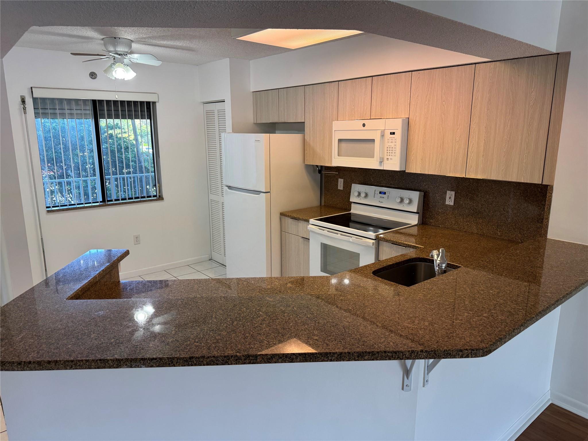 LARGE 3 BEDROOM INTERIOR CORNER CONDO WITH GORGEOUS LAKE VIEW FROM EVERY ROOM! UPDATED AND OPEN KITCHEN WITH GRANITE COUNTERTOPS! BIG SCREENED BALCONY OVERLOOKING WIDE LAKE. STORM SHUTTERS. INSIDE UTILITY ROOM WITH FULL SIZE WASHER/DRYER. EXTRA STORAGE ROOM JUST STEPS AWAY. GREAT LOCATION CLOSE TO "THE POMP" WITH CASINO AND TOP GOLF. SHOPS AND RESTAURANTS CLOSE BY! MAY HAVE A SMALL PET WITH PET DEPOSIT.