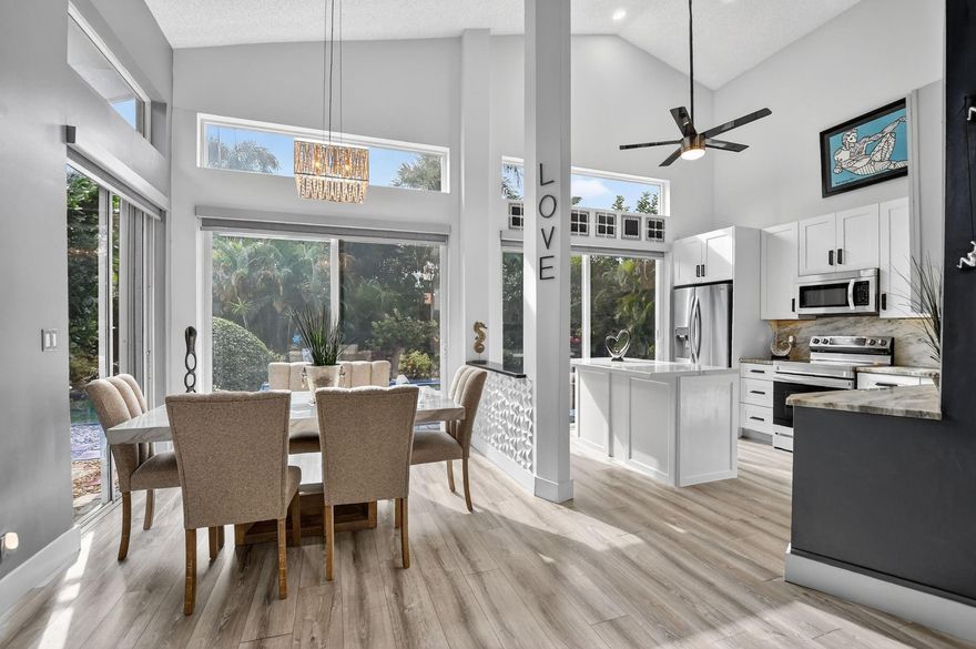 Live the life at Newport Bay Club with no buy-in fees.  NBC has 225 homes, 24 hour manned-gate, gorgeous, updated clubhouse with fitness center, heated/chilled resort-style pool, pro-shop, 7 tennis courts, 4 pickle ball courts, basketball court, and play area. On Jog Rd, near Morikami gardens, shopping, great schools and Starbucks!  This home is an oasis...sitting on a private corner lot.  Host a pool party and impress friends with your remodeled kitchen with white cabinets, ss appliances, granite counter tops and island.  The primary BR suite feels like a spa with soaking tub, double vanities, and custom closet.  Natural light fills the space, especially in the common areas with the high ceilings.  Enjoy updated flooring throughout and impact sliders leading to the pool.   Move-in ready!