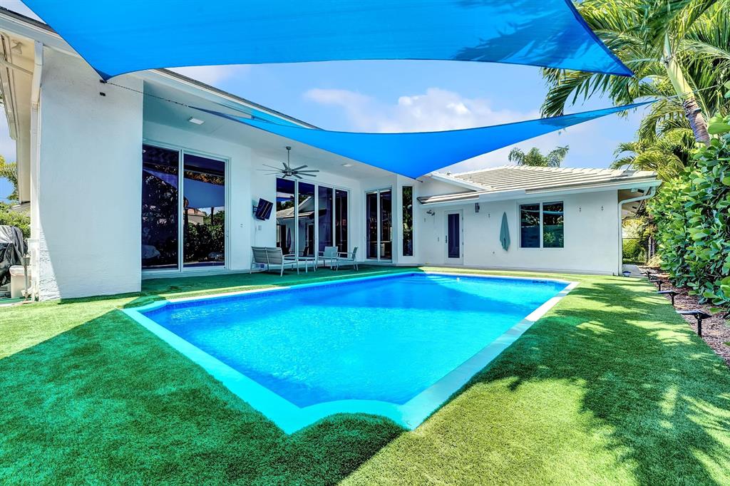 SPECTACULAR! Total renovation is complete! WATERFRONT leading to Lake Ida. Dock your boat in your own backyard! Walk through the double doors into a light and bright open floor plan with 12' ceilings, new oversized Italian porcelain floors, and new upgraded impact windows and doors throughout. The new Chef's kitchen features 2 freestanding kitchen islands, quartz countertops, under draft exhaust for large induction cooktop, Sub Zero refrigerator. Seamlessly flow outdoors through the oversized glass doors into a tropical oasis. 8' deep pool with heater/chiller, 12' covered patio, premium smart turf pool surround with drainage panels, tropical plantings offer backyard privacy, and new boat dock which leads to 3 lakes. Other features include fireplace, new roof, new oversized driveway.