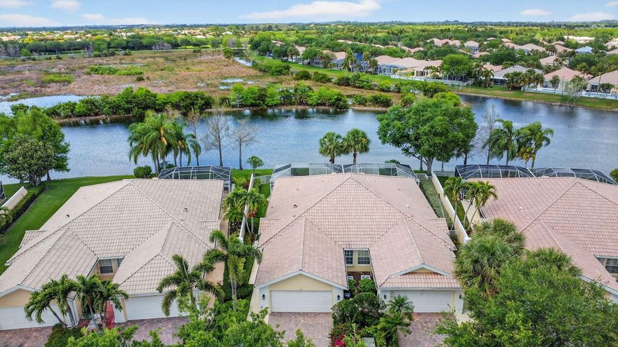 RARE OPPORTUNITY - STUNNING PRESERVE & EXPANSIVE LAKE VIEWS!  Don't miss this beautifully maintained EXTENDED Capri model villa situated on a PREMIUM preserve and lakefront lot in the highly desirable VillageWalk of Wellington.  This 2-bedroom, 2-bath home with a  private pool and 2-car garage offers some of the most breathtaking preserve views in the community, creating the perfect setting for spectacular sunset views from your screened patio. This light and bright home features new luxury vinyl flooring in the bedrooms and family room, neutral tile throughout the main living areas, and new white ceiling fans throughout.  The popular split floor plan provides excellent privacy, with the primary suite offering tranquil preserve views, a walk-in closet, and an en-suite bath. The guest bedroom is positioned on the opposite side of the home and features its own walk-in closet with a full bathroom nearby. The spacious family room overlooks the pool and serene preserve, creating an ideal space for both relaxing and entertaining. Accordion hurricane shutters provide added storm protection and peace of mind. VillageWalk offers exceptional resort-style amenities including: Lighted clay tennis courts, pickleball, resort and lap pools, fitness center, basketball, bocce ball, library, salon, pet spa, playground, miles of scenic walking paths, a 24/7 manned guard gate, on-site management, and a full calendar of social events. Coming soon: A fully renovated community restaurant by the Fashion Group (Oli's Fashion Cuisine, Emiliano's, and Stallion Steakhouse). HOA includes: premium cable, high-speed internet, lawn care, alarm monitoring, exterior painting, roof pressure cleaning, and full amenity access. Ideally located near WEF, International Polo Club, shopping, dining, and top-rated Wellington schools. Built by Divosta with solid poured concrete construction known for quality and durability. Updates include: HVAC (2019) and water heater (2020). Schedule your private showing today.