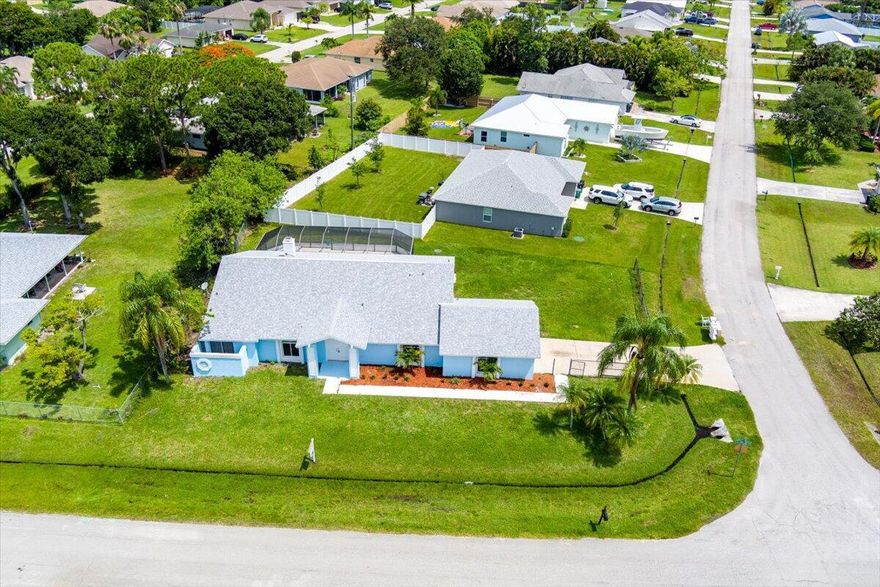 Move in ready! 3/2/2 with sparkling Screened POOL and patio that is perfect for entertaining. NEW ROOF June 2023! Open concept that features a great room, custom fireplace, granite kitchen with wood cabinets, gas stove, stainless appliances, breakfast bar and dining area. Huge owners suite with separate are for office / flex space and sliders to the pool. Tons of closet space, ensuite bath, custom shower, walk-in spa tub and new vanity! All new paint inside and out, all new flooring, fixtures and more! Inside laundry comes with washer and dryer! Home sits on an oversized corner lot! Top east of US1 location convenient to area beaches, schools and shopping. Just minutes to downtown Jensen Beach and Stuart!