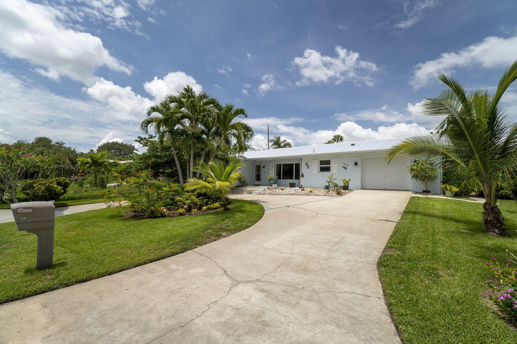 Live Just Steps from the Indian River in Charming Jensen Beach!Welcome to your very own slice of paradise! Located just across from Indian Riverside Park and the U.S. Sailing Center, this beautifully updated single-family home offers the best of Florida living. Wake up to breathtaking sunrises and gentle river breezes as you sip your morning coffee on the inviting front patio. Inside, you'll find a bright and airy 2-bedroom 2-bath interior featuring a spacious Florida room perfect for a home office, gym, guest room, or entertainment space. Recent upgrades include a new (2021) metal roof, water heater, garage door, dishwasher (2023), front impact windows, and a mix of stylish tile and laminate flooring.Nature lovers will fall in love with the lush backyard a tropical oasis filled wit