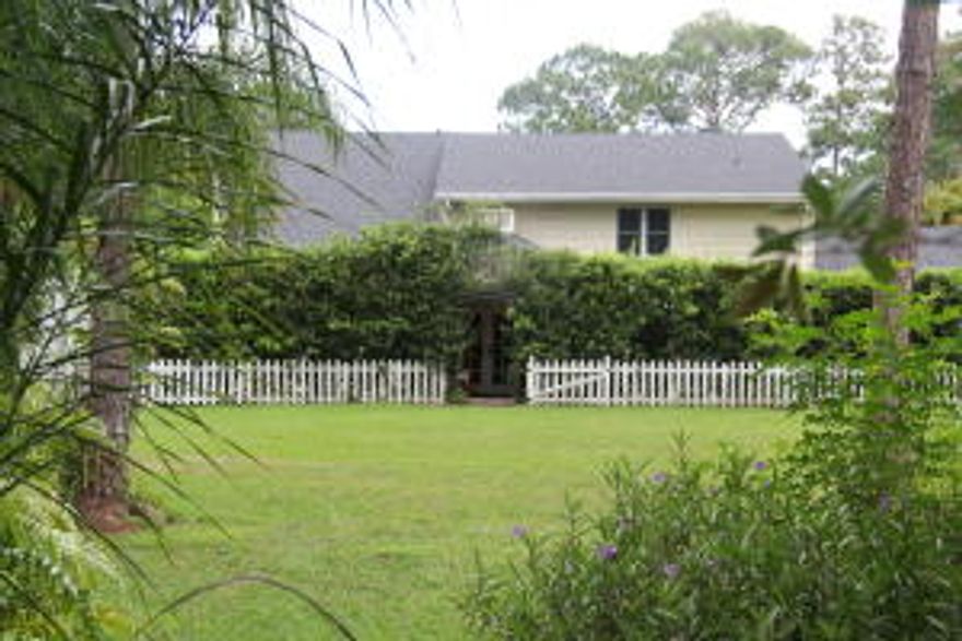 2.5 fenced and gated acres of beautiful landscaping cared for by 25 yr resident. 3/2 plus bonus room, brick paved covered patios and green houses adjacent to home.  Vinyl lifetime siding, New Roof, replaced last year, 2 A/C's 1-3yo and 1- 6 mos old. Impact window and doors. 2 story living area,  fireplace w stone surround to vaulted ceiling and library loft overlooking, beveled leaded French doors lead to dining area with sliders to patio. Immense kitchen area, movable island, granite counters, ample cabinetry, wrought iron pot rack,  Staircase similar to Downton Abbey, wood moldings, large master suite, bath and closet. Master could be converted to 2 bedrooms.  Storage sheds on property.