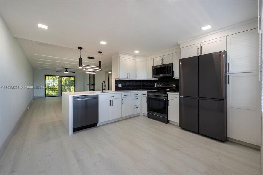 EVERYTHING NEW!  Discover this meticulously renovated 2-bed, 2-bath haven in Wynmoore at Coconut Creek. This stunning home features scratch-proof/waterproof floors, 6'' baseboards, black stainless Samsung appliances, and elegant white shaker cabinets. Enjoy Carrara quartz countertops with a waterfall side, a 36'' electric fireplace, and built-in closets in both bedrooms. Modern comforts include touch-free toilet flush systems, digital temperature sensing sink faucets, and floating vanities in both bathrooms. Indulge in the guest shower with body jets, rainfall head, and LED mirrors. This residence redefines sophistication. Adult Community amenities include golf, pickle ball, tennis, swimming, movie theater, games, Art, crafts, and more. A paradise of luxury and leisure awaits! Call today