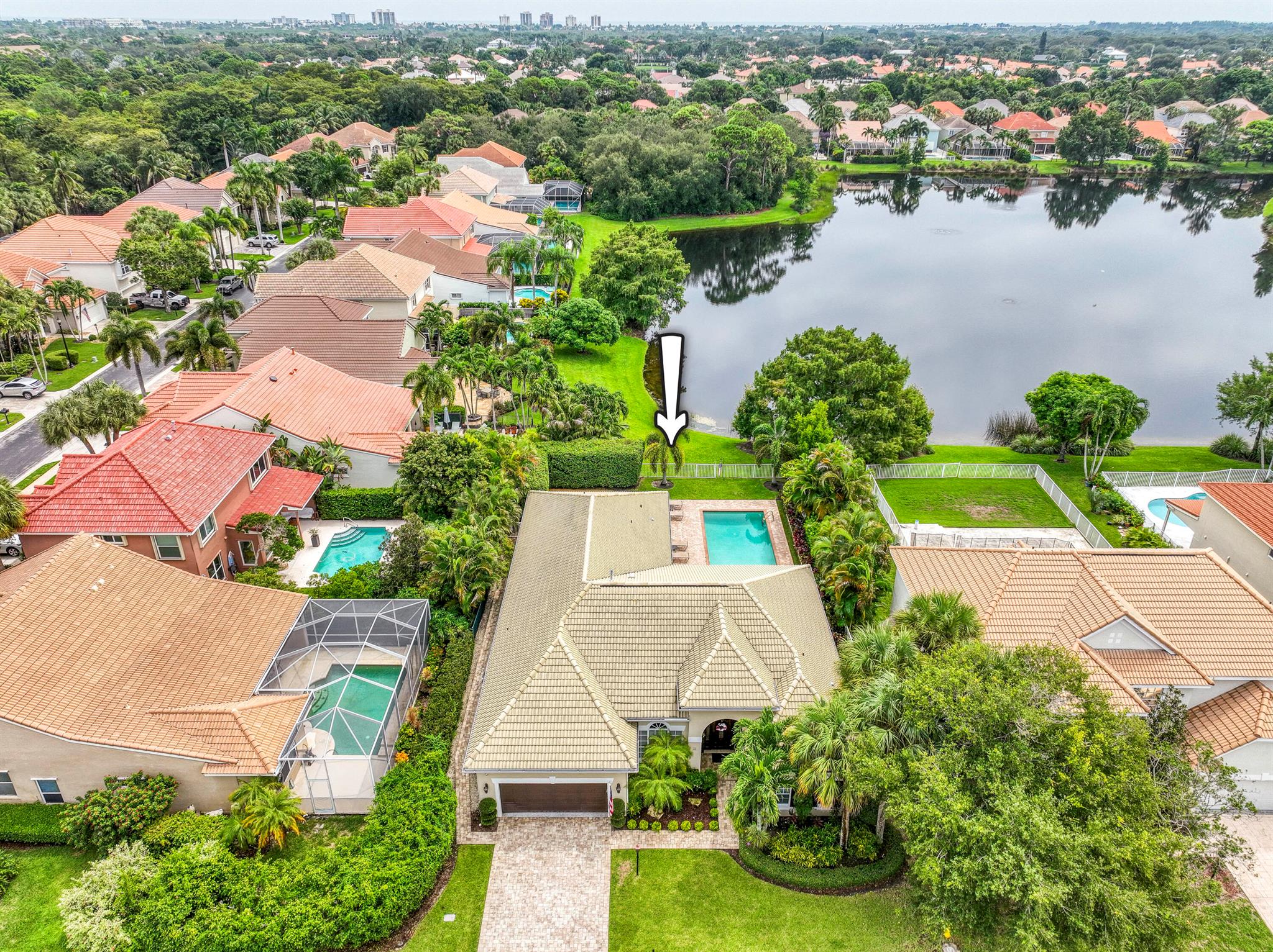 Welcome to this beautifully maintained CBS single-family home, offering 4 bedrooms, 3 bathrooms, and 2,671 sq ft of living space. Perfectly situated on a 9,099 sq ft lot in the gated Sanctuary community, this home blends elegance, functionality, and peace of mind. The light-filled living room features warm wood flooring, soft buttery walls, and French doors opening to the pool. The adjacent dining room boasts a large arched window with plantation shutters and a bronze chandelier, ideal for intimate or formal gatherings. The kitchen offers custom ecru-toned cabinetry with aged bronze accents, granite countertops, stainless steel appliances including double ovens, a wine chiller, and a five-burner gas cooktop. A snack bar and cozy breakfast area complete the space. The bright family