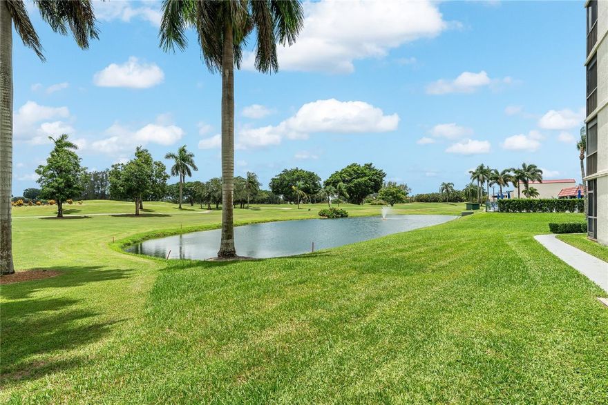 GOLFER'S DELIGHT! 1ST FLOOR PANORAMIC PGA GOLF (PGA 3RD GREEN) & WATER VIEWS! 1BR/1.5BA featuring WOOD plank flooring. KITCHEN FEATURES GRANITE COUNTERS AND SNACK BAR. CROWN MOLDING. TOTAL APPLIANCE SERVICE CONTRACT. Updated shower in master bathroom. GOLFERS EXCELLENT OPPORTUNITY WELL BELOW ASSESSED VALUE! $3,000 a year is far less than joining a Golf Club. FREE golf (except cart fees) on two 18 hole courses (PGA & Par3); Amenities include Restaurant, Billiard Room, BBQ/Picnic Area, Clubhouse, Courtesy Bus, Exercise Room, Heated Pool, Library, Putting Green, Sauna, Shuffleboard, Tennis, Pickle Ball, Vehicle Wash Area, Electric Car Charging Station. Close to shops, dining & highways. 15 min. to the beach. Association says 55+ age required; CHEAPER THAN JOINING ANOTHER GOLF COUNTRY CLUB!