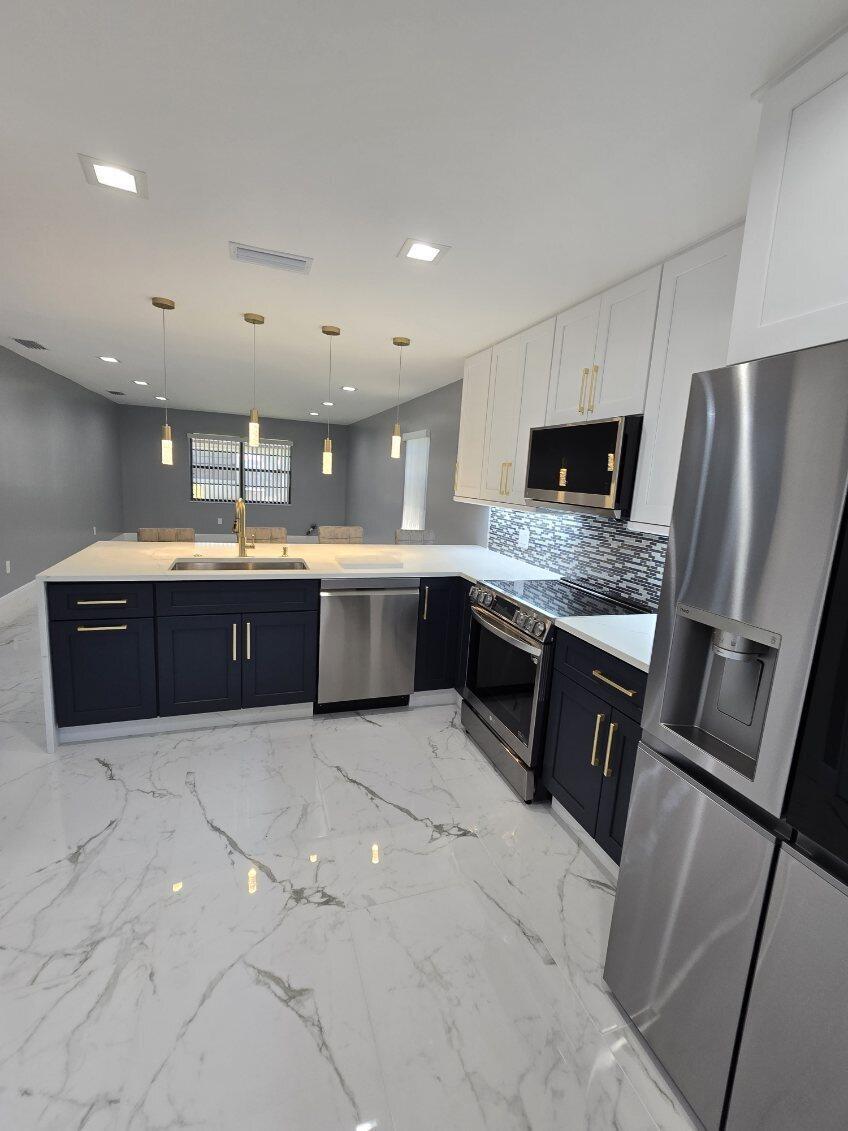 Freshly painted corner unit! Completely Upgraded Brand NEW. The Kitchen features New Quartz Countertops, New Wood Kitchen Cabinets, New Stainless-Steel Appliances, New Porcelain Tile 48 X 24 thru out the whole place. Central A/C, washer & dryer in unit. Beautiful Main Bath & Guest Bath, Custom Closets. 2 Parking Space with a Garage. Community Pool. Give me a call to schedule your personal tour today, I can't wait to show you your new home!