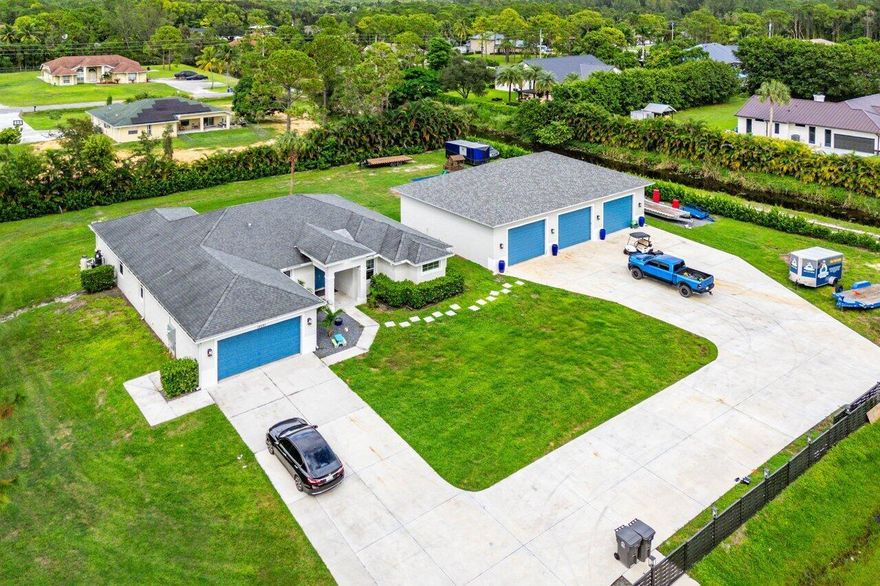 Built in 2020, but, THIS IS BETTER THAN NEW!! High standards and pride of ownership were done from Day 1 both inside and outside the home! A show stopper and rare find is the 2,400sqft CBS detached garage with it's own private office and AC!  This is a DREAM HOME for the entire family! There were 360 clusia trees planted along the entire perimeter of the home to truly give you that private oasis! Fully fenced 1.31 acres with a BRAND NEW electric gate in the front and custom lighting done throughout the entire exterior the home!  The entire property is high and dry with over 300 truck loads of dirt brought in to ensure there is no sitting water. Brand new AC in 2024, water filter 2023, crown molding, added high hats and so much more! Schedule your private tour as soon as possible!