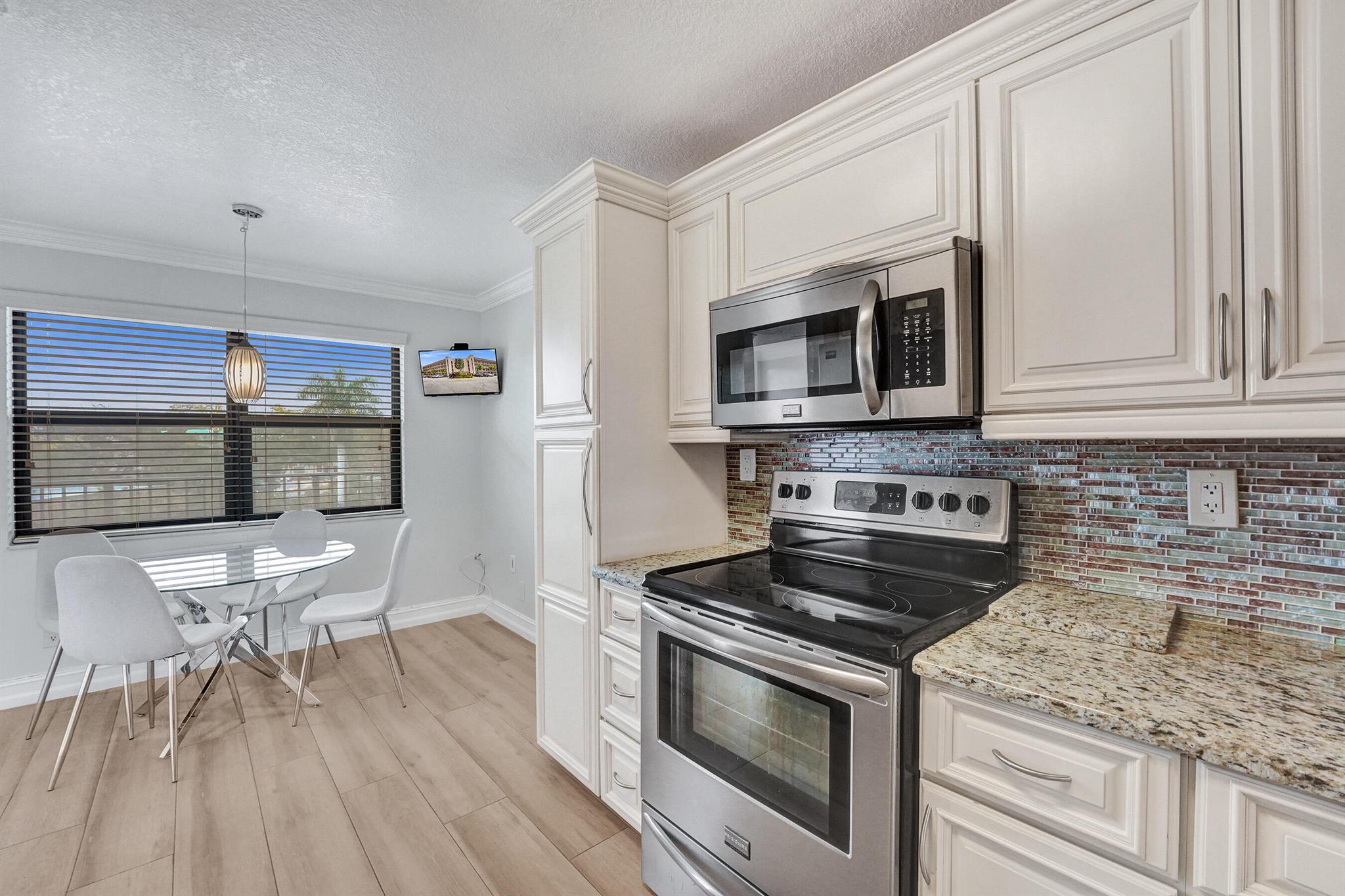 Updated & Move-In Ready! This bright unit features impact glass, brand-new A/C, stylish laminate floors, and a versatile layout. Enjoy a spacious primary suite, in-unit laundry, and a cozy breakfast nook with peaceful views. Located in Sunrise Lakes with pool, golf, clubhouse--just minutes from Sawgrass, shopping, and dining.