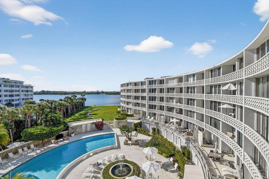 Indulge in the epitome of Palm Beach luxury in this exclusive residence, boasting deeded ocean access and breathtaking vistas of both the shimmering resort-style pool and the tranquil Intracoastal Waterway. Immaculate modern white tile flows seamlessly throughout, complementing the sophisticated ambiance of this iconic mid-century building, which features a pristine fitness center, an elegant card lounge, attentive on-site management, and curated social events. Just moments away, discover world-class Par 3 golf, acclaimed fine dining establishments, and upscale shopping destinations that define a life of prestige and comfort.