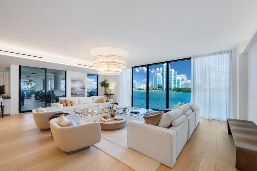 Set within Fisher Island, the richest zip code in the world, this exquisitely tastefully and completely remodeled residence is located in the Island's newest and most exclusive building, Palazzo Della Luna- a rare sanctuary where privacy, prestige, and timeless elegance converge.
Feel the ocean breeze as you sit directly on the South Point Inlet, breathing in the heartbeat of South Beach and South Pointe Park. Watch yachts glide through Government's Cut while taking in some of the most captivating views Miami has to offer, all from one of the most coveted islands in the world. 
This exceptional, fully furnished corner residence features a private elevator entry and offers 4 bedrooms, and 4.5 bathrooms across 4,904 square feet of refined luxury. Wide-plank oak floors flow effortlessly through expansive living, dining, and family spaces, each opening to a dramatic wraparound terrace designed for elevated entertaining, Unobstructed vistas of Biscayne Bay, Government Cut, Miami Beach, and the Atlantic Ocean create a breathtaking backdrop from every angle.
The custom Boffi kitchen is a work of art, appointed with sleek granite countertops and top-of-the-line Miele and Sub-Zero appliances. The serene primary suite is wrapped in floor-to-ceiling glass, revealing mesmerizing water views, dual walk-in closets , and spa inspired bath adorned with Carrara marble, a soaking tub, and rain shower. Three additional guest suites offer generous proportions and elegant en-suite baths, ensuring comfort for all.
One of the largest wraparound terraces in the building -paired with an additional rear terrace-provides an extraordinary 2,417 square feet of outdoor living space, perfect for sunrise coffees, sunset cocktails, and unforgettable evenings under the stars.
This is more than a residence-it's a dreamlike escape, a statement of taste, and a rare opportunity to own a masterpiece in Fisher Island's most prestigious address.