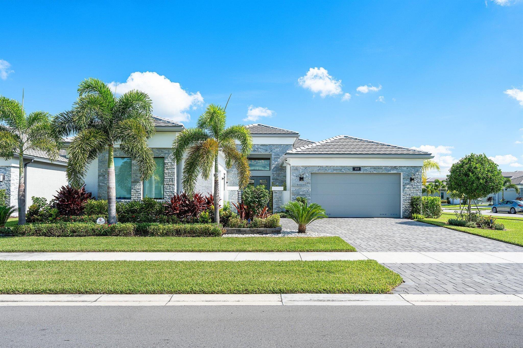 No expense has been spared in this designer perfect Carlyle model. Great curb appeal-lush landscaping, stone front, privacy gate and glass doors. The home (3/3.1+Club Room+3cg) sits on an oversized corner lot & has impact windows, full house generator, two mini split A/C's in garages, 24'' porcelain tile floors, designer window treatments & light fixtures, hi-hats, fans, designer wall treatments, built-ins, custom closets, upgraded baths + more! Gourmet kitchen w/gas, white cabinets, quartz counters, counter depth snack bar, stainless hood, Viking d/w & range, wine fridge, center island with marble counter & more! Luxury master suite. You'll love the ''backyard resort'' with marble deck, summer kitchen, birdcage w/picture frame screen, open pool, cabana bath, grassy areas & view of lake