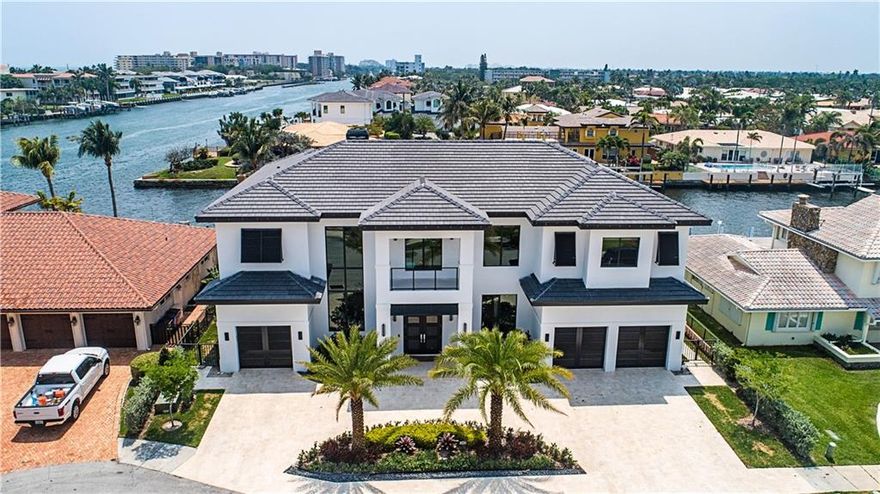 New Construction masterpiece one lot off ICW w/ Southern Intracoastal views and 90 feet on the Kingfisher canal. Must see to appreciate the many high end features of this remarkable home. 5 BR w/ in suite baths + half bath & exterior full cabana bath.  Gourmet kitchen w/ high end Wolf/Subzero appliances & fine modern Italian cabinetry. 48" square porcelain tile thru out liv areas  3 car garage designed for lifts* Elevator ready*Natural gas to stove*Navina recirculating water heaters*pool heater*summer kitchen.  A gas line is plumbed to add a generator. The awesome backyard has shell stone surrounding the 40x15 saltwater heated pool w/ an amazing floating spa in the sun shelf $ water steps. The shell stone also covers the 80 foot concrete dock that has two lower boarding levels & boat lift