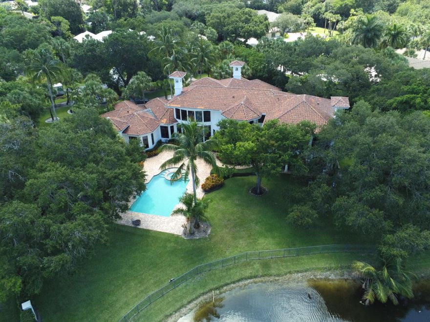 THE BEST WATERFRONT LOT IN FOXE CHASE! This spectacular 10,903 +/- Sq. Ft. family estate is sited on a magnificent 1+/- Acre lakefront lot in the prestigious guard gated enclave, Foxe Chase, one of the most beautiful communities in South Florida. Just 3 miles to the Atlantic Ocean, this is the eastern most community in South Palm Beach County offering all one acre lots and includes 43 homes sites surrounding a central lake with cascading waterfalls! A large circular brick paved driveway surrounded by mature lush landscaping, leads to a private walled and gated entry to the residence. The impressive 10-foot front door opens to a welcoming foyer which opens to a breathtaking scene, a magnificent living room with volume ceilings, fireplace, and walls of glass. Tastefully redone first floor Master Suite with unobstructed lake views. Private octagonal sitting area and private his and hers Master bathrooms. Adjacent to the Master Suite is the beautiful library/office with fireplace and again, spectacular pool area and lake views! The magnificent remodeled oversized double island kitchen with top of the line appliances is open to a huge double family room with French doors opening to a covered lake front loggia with summer kitchen and outdoor fireplace, pool area and rear grounds. A spacious Day Spa is adjacent to the family room and the four garage bays are accessible from the kitchen. The second floor is accessed by a beautiful winding staircase and is comprised of large fully outfitted gym and 4 large en-suite bedrooms, each with a private balcony overlooking the lake. Whole house water softener system by Kangen. State-of-the-art entertainment system. Smart Home with upgraded one touch lighting, HD interior and exterior cameras, all controlled via iPad. A truly magnificent​​‌​​​​‌​‌​​​‌‌​​​‌‌‌​​‌​​‌‌​​​​ Estate.