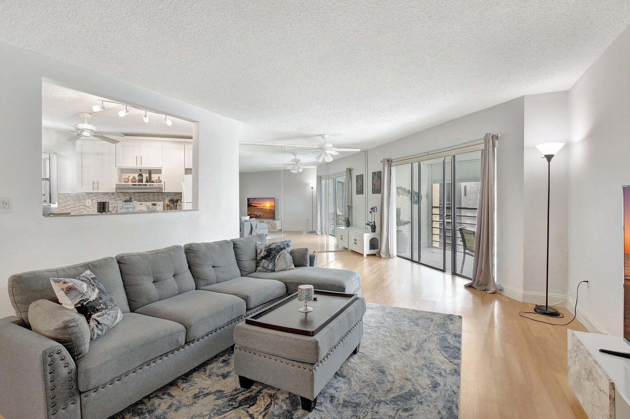 SELLER MOTIVATED! Must-see top-floor, corner-unit condo in the highly sought-after, all-ages community of Plantation Club. This 2-bedroom, 2-bathroom home features a bright, open floor plan with abundant natural light. The screened patio offers serene views of the garden area. The fully remodeled kitchen boasts modern wood cabinetry, granite countertops, a stylish patterned backsplash, additional counter space, a convenient passthrough to the living room, and a stainless dishwasher. In-unit washer and dryer included. The condo is finished with laminate and tile flooring throughout. The master suite offers a walk-in closet and direct balcony access. Community amenities include a pool, hot tub, and clubhouse. Conveniently located within walking distance of parks, grocery stores, restaurants
