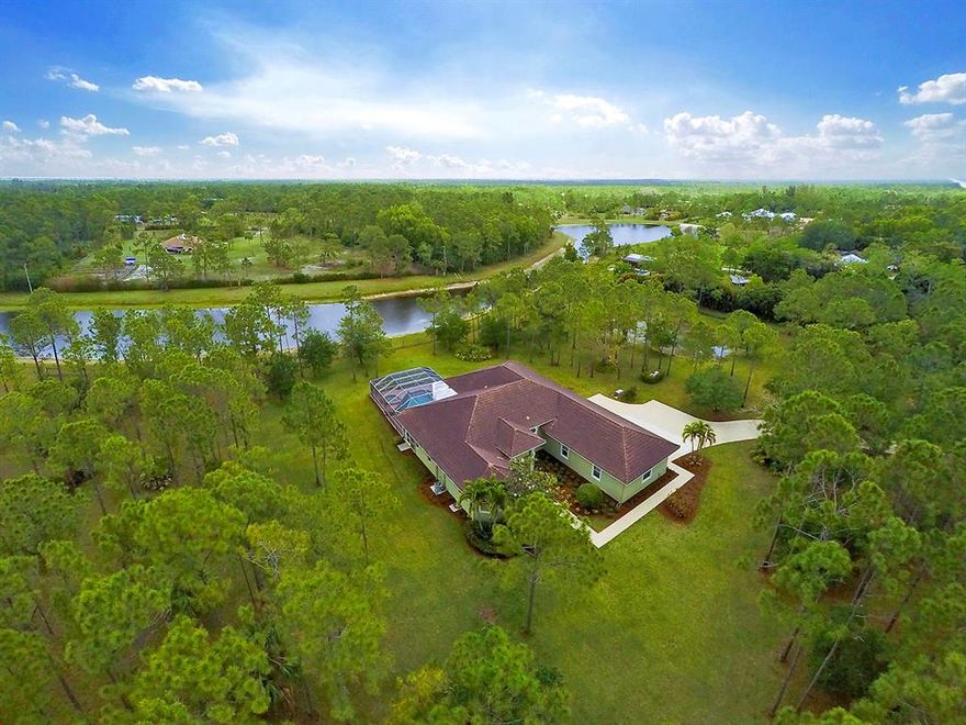 Wonderfully updated fully fenced pool home with attached 3 Car Garage, located on 5 Acres in the Equestrian community of Caloosa. Custom Built in 2003 with four bedrooms plus a built-in office. High ceilings with oversized crown-molding throughout. Living areas have ceramic tile on the diagonal, wood in the office and new carpet in all the bedrooms. Desirable split floor plan with large master suite. Large screened patio/pool and spa - great for entertaining. Home Generator - All Windows and Doors are Hurricane Impact - Sprinkler system on property which feeds from the canal.