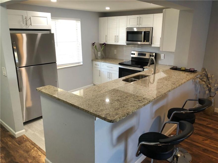 GORGEOUS, TOTALY RENVOVATED GROUND FLOOR CONDO WITH BEAUTIFUL DIRECT LAKE VIEWS. PARK IN FRONT AND WALK INTO YOUR UNIT WITHOUT ELEVATOR OR STAIRS, WALK RIGHT OUT YOUR BACK SCREENED IN PATIO TO SERENE LAKE. NEVER LIVED IN SINCE FULL RENOVATION. NEW A/C SYSTEM AND NEW WATER HEATER. STYLISH WOOD FLOORS, NEW OPEN KITCHEN WITH NEW STAINLESS STEEL APPLIANCES, NEW KITCHEN CABINETS WITH GRANITE TOPS.  SHORT WALK TO POOL AND CLUBHOUSE. COMPLETELY NEW BATHROOMS , WITH NEW CABINETS, QUARTZ TOPS, NEW TOILETS, NEW SHOWER/BATHS WITH GLASS DOORS AND NEW TILE. NEW LIGHTING/FANS. LOTS OF CLOSET SPACE WITH EXTRA STORAGE UNIT. VERY CLOSE TO CASINOS, SHOPPING, BEACHES,RESTAURANTS, PUBLIX AND FT. LAUDERDALE AIRPORT. KNOCK DOWN CEILINGS. 55+ BUILDING