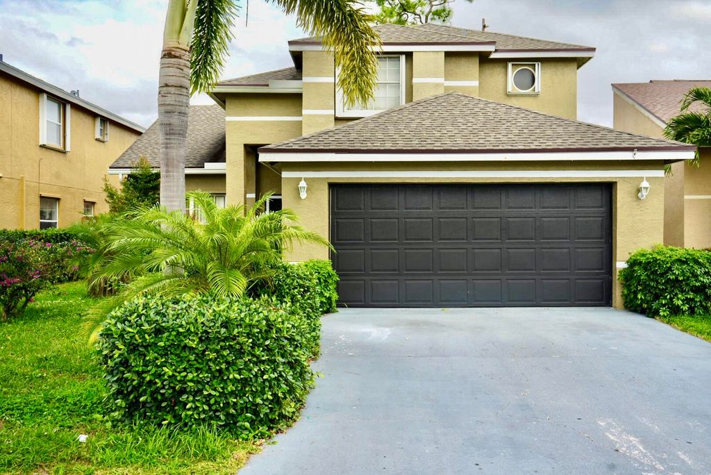 Photo of 133 Heatherwood Drive, Royal Palm Beach, FL 33411 (MLS # R10953912)