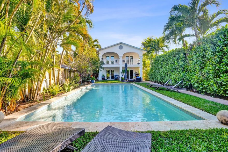 Recently improved pricing offers a renewed opportunity! Behind the gate, this home opens to a private tropical oasis. A resort-style heated pool anchors the front yard, creating a true indoor-outdoor lifestyle ideal for entertaining or relaxing in complete privacy. The main level offers open living space with an updated kitchen and full bath. A separate studio suite with private entrance, kitchen, and full bath provides flexibility for guests, multigenerational living, or potential vacation rental. Impact windows and doors throughout ensure safety and peace of mind. Upstairs features an expansive primary suite with spa-inspired bath, walk-through closet, and oversized balcony overlooking the pool. Two additional bedrooms complete the second level, including one with a full ensuite bath.