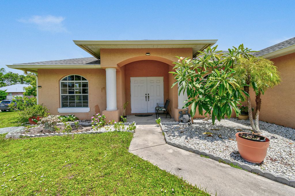 Photo of 1671 SW Mackey Avenue, Port Saint Lucie, FL 34953 (MLS # R11112356)