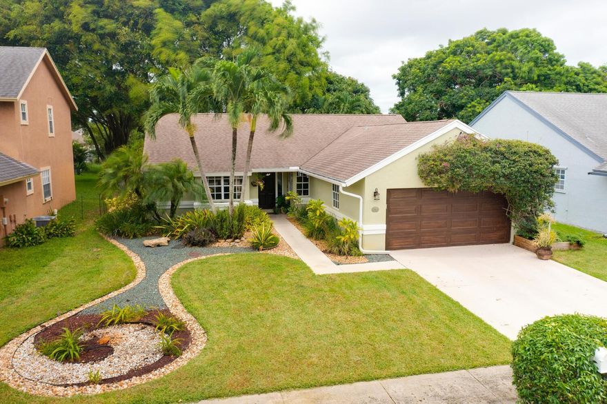 Centrally located within a gated community, this Spanish-style ranch home has everything you have been looking for! As you approach, you are welcomed with immaculate landscaping, both hard & soft scapes evoke inviting emotions from the moment this home comes into view. As you enter, you are greeted with tongue & groove cherrywood ceilings, natural light from every angle & long lake views. The open floor plan & updated kitchen make this home an entertainer's dream. The kitchen offers updated wood cabinetry, granite countertops, stainless steel appliances, a breakfast bar & lots of storage. The primary suite features vaulted ceilings, real wood floors, an enormous built-out closet & ensuite bathroom. Both guest rooms offer real wood floors, large closets and share an updated bathroom. Step outside to the fully fenced-in backyard & enjoy magnificent long lake views. A custom-built bar/summer kitchen lets you enjoy a true indoor-outdoor living space. No detail has been overlooked, call today for a private showing before it's too late! AC-2017, Roof-2005, Washer/Dryer & Husky storage in the garage do not convey.