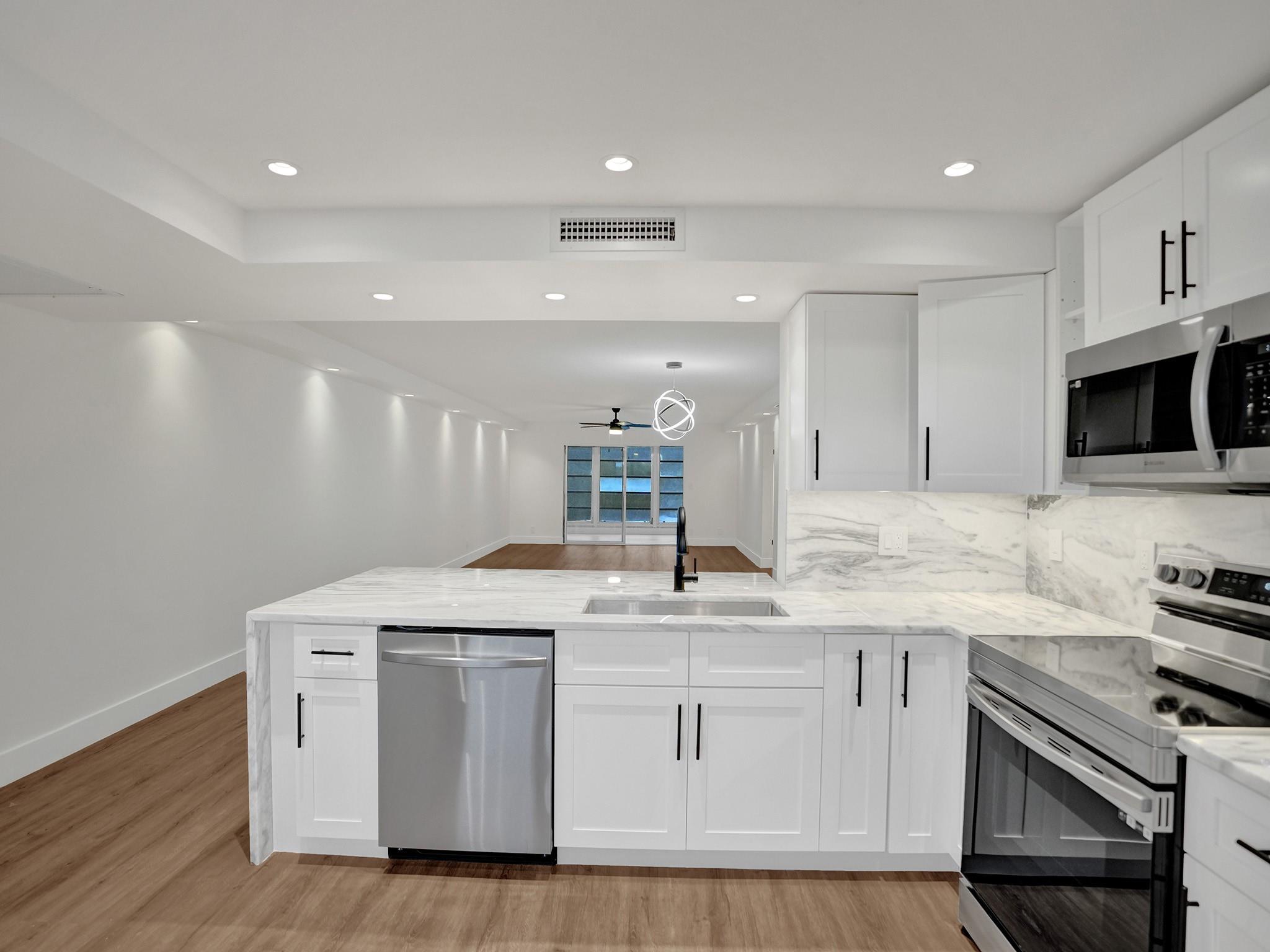 NEWLY RENOVATED, 4TH FLOOR, LARGEST CORNER LUXURY MODEL IN WYNMOOR with WASHER & DRYER! Step into luxury with this expansive 2-bed 2-bath unit within the vibrant 55+ Wynmoor Village. Revel in imported marble from Spain gracing the countertops, complemented by chic white shaker cabinets and modern black metal accents. Indulge in top-of-the-line stainless-steel appliances & stylish light fixtures. This lavish haven boasts its own washer and dryer, ample closets, and tiled patio. Dive into a world of resort-style amenities, clubhouse to an 18-hole golf course, heated pools, sauna, tennis, pickleball, fitness center, & an array of conveniences including doctors' offices, pharmacies, theaters, and more. Live the lifestyle you deserve at Wynmoor!