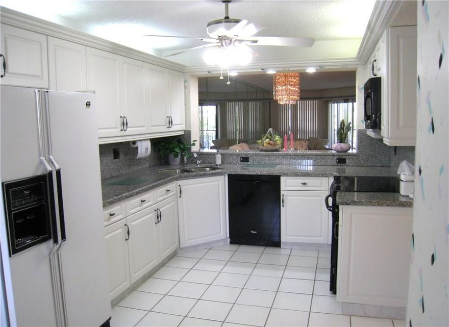 CHECK OUT DECORATING ALLOWANCE OF $3000 FOR WALLPAPER REMOVAL.DON'T MISS THIS SPOTLESS QUEEN MODEL.  REMODELED KITCHEN AND MASTER BATHROOM. KITCHEN HAS FLAT TOP STOVE AND NEW STATE OF THE ART FANS. CLUBHOUSE DEED PAID IN FULL. HURRICANE RESISTANT GLASS DOORS ENCLOSE PATIO WITH GORGEOUS WATER VIEW. CLOSETS OUTFITTED WITH CALIFORNIA CLOSETS. COURTESY BUSES GO TO CLUBHOUSE, THEATER, MALLS, SHOPPING ETC. ASSOC STATES  55+ AND NO RENTING UNTIL 1 YEAR OWNERSHIP