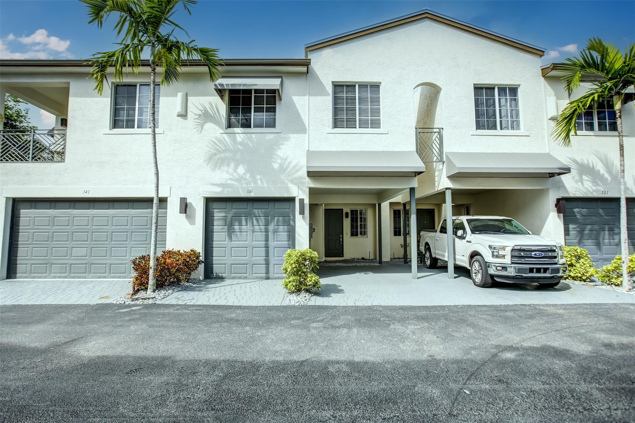 Experience luxurious living in this stunning townhouse, fully remodeled with an open floor plan and high ceilings, creating an airy and spacious atmosphere. It includes 3 bedrooms and 2½ baths, featuring two walk-in closets in the master bedroom for ample storage. The property also offers a one-car garage and an additional covered parking spot within a sought-after gated community. High-impact windows and an aluminum roof enhance energy efficiency to help reduce cooling costs. Conveniently located just 1.5 miles from the newly renovated Pompano Beach, this home beautifully combines elegance and convenience. May rent townhome 2 times a year at a minimum of 3 months