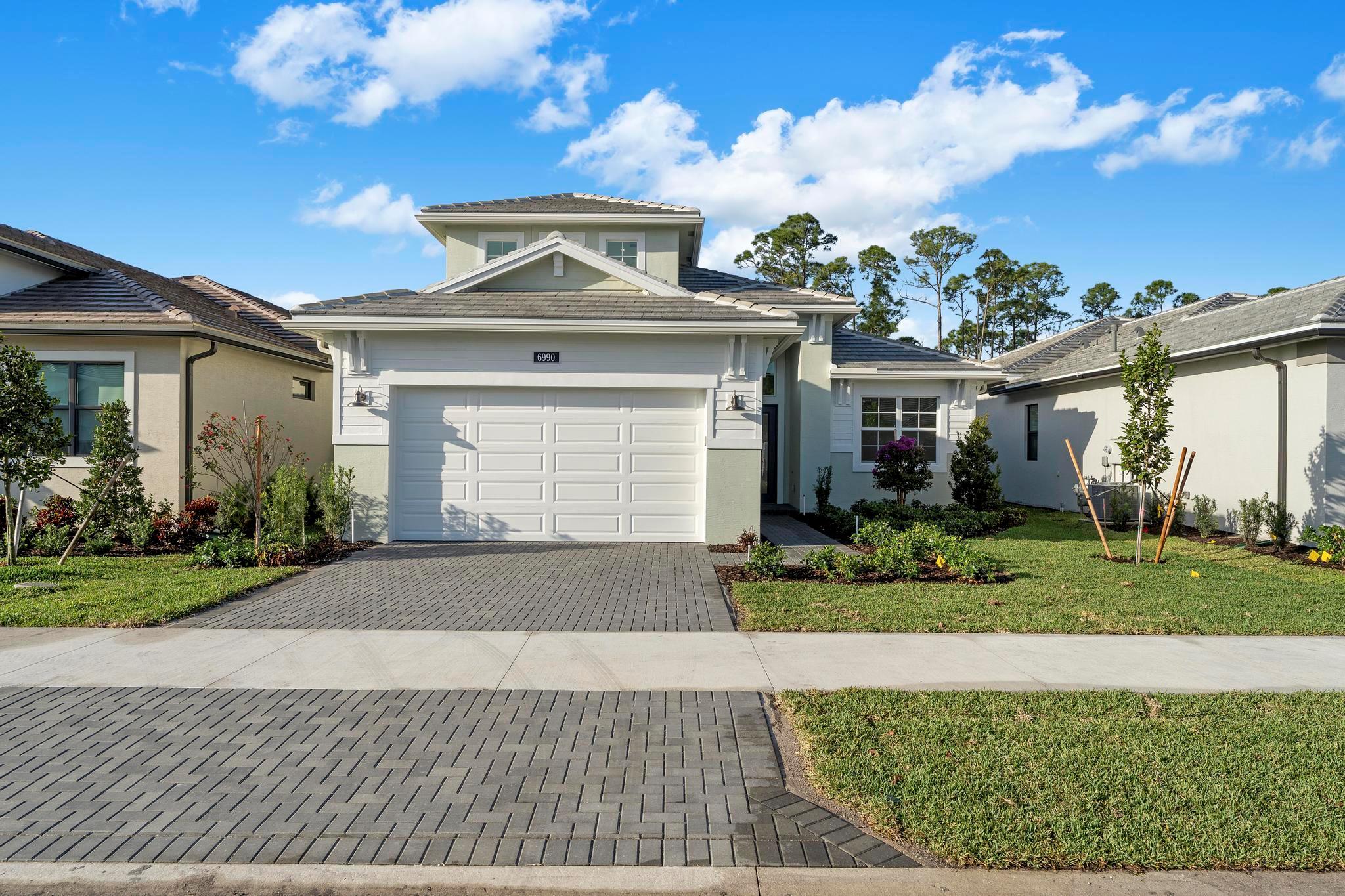 $140,000 in upgrades, New construction! Available for immediate occupancy. Lowest price per sqft in Cove Royale! This gorgeous Lila model is the ULTIMATE IN LUXURY LIVING! 3 (poss. 4)bed 4 bath + flex Oversized gourmet kitchen with gas cooktop, wall oven, 3'' quartz counters, cabinets galore, large pantry and more! Open concept with electric fireplace and oversized sliding impact glass doors opening to covered lanai for abundant light and beautiful preserve views. Wood laminate flooring throughout entire main level & bedrooms. Expanded owners' suite, beautiful ensuite bath with walk in shower and huge walk-in closet. Upstairs bonus room offers full bath & walk-in closet perfect for 4th bedroom, guest suite, game room or office. Convenient to shopping, restaurants, beaches, schools and I95