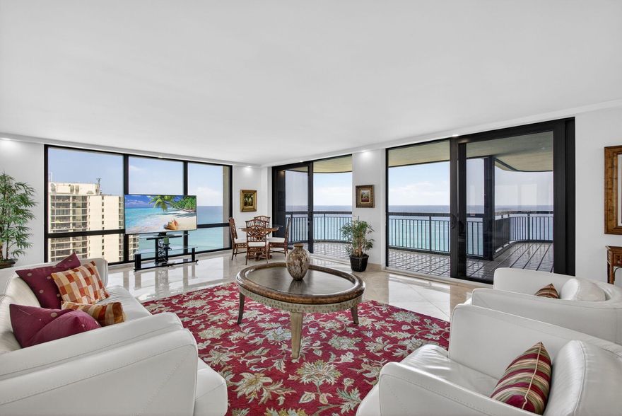 Panoramic ocean and intracoastal views surround this 24th-floor corner residence, offering eastern, northern & western exposures and fabulous sunrise-to-sunset views. Ideally positioned just below the penthouse, this premium tower location provides both privacy and sweeping water and island scenery. Located on the quiet north end of Singer Island, with convenient access to PGA Blvd for world-class shopping, dining, and entertainment, this spacious condominium features a sprawling floor plan with 3 bedrooms and 3.5 bathrooms. The residence was thoughtfully updated in 2023 with a brand-new kitchen redesigned to create an open-concept living space ideal for entertaining. Highlights include custom white cabinetry, quartz countertops, two refrigerators & oversized island. >> Floor-to-ceiling hurricane impact glass windows highlight the stunning water views from every window. Additional features include a double-door front entry, a full laundry room in the unit, and a large private storage closet conveniently located in the hallway just outside the front door. Italian marble flooring flows throughout the main living areas and primary suite, while the guest bedrooms feature beautiful wood flooring in a coastal color palette. An expansive 740 sqft of wraparound balconies for outdoor living, protected by accordion storm shutters. Brand new A/C has just been installed. Water heater is 2022. Featuring only 3 units per floor, this luxury oceanfront tower has undergone extensive renovations both inside and out, including a new seawall and a raised lower sun deck with beach sand and lounge chairs overlooking the ocean. Residents also enjoy a fabulous tropically landscaped pool area with open and shaded seating, spa, 24/7 manned security gate, updated lobby with front desk attendant, fitness center, community room with library, game room and on-site property manager. All special assessments have been paid by the seller. Offered fully furnished turnkey or unfurnished, the choice is yours. Watch dolphins, manatees, sea turtles and more from your balcony. Welcome home!