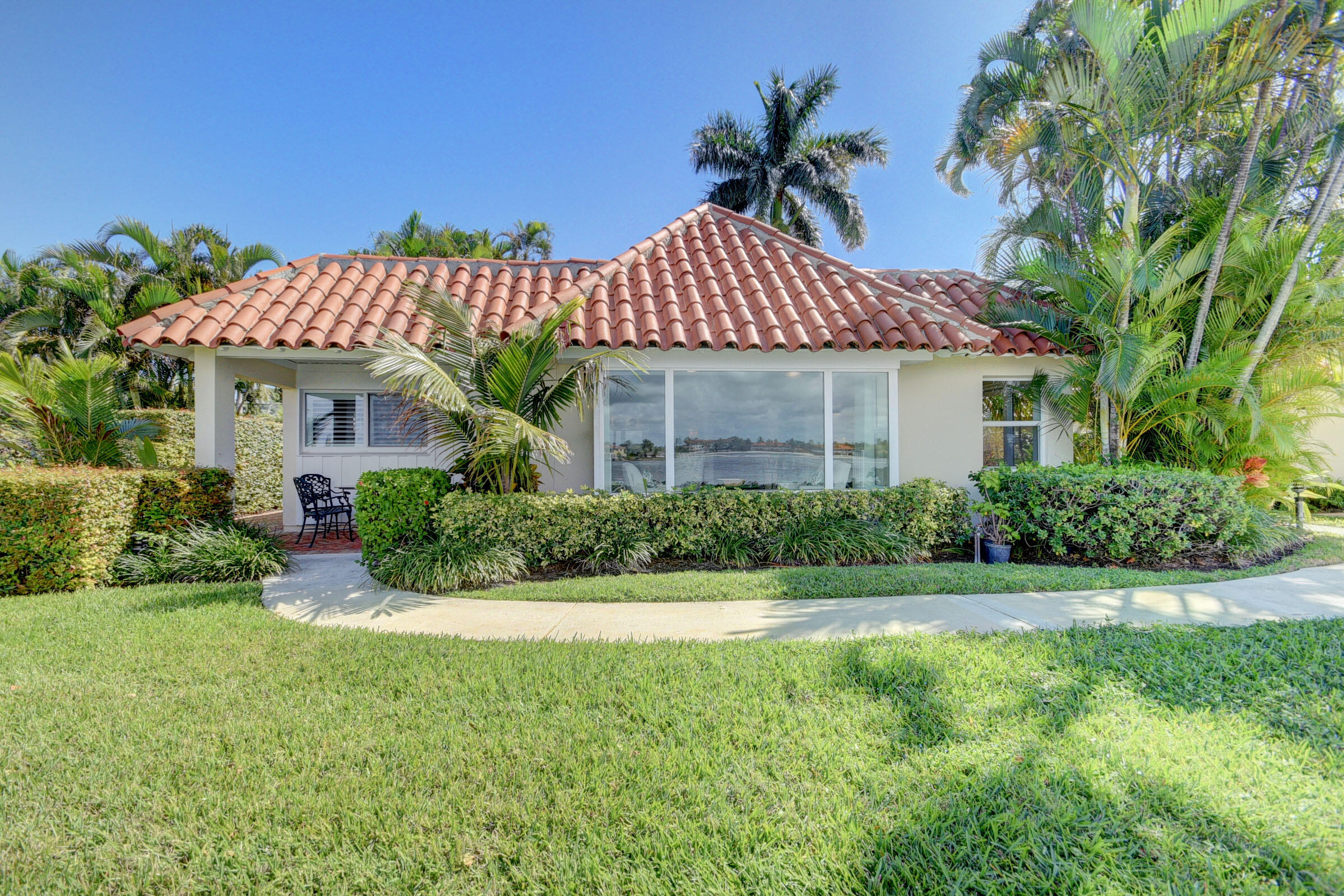 Rare opportunity to own a Cottage Colony villa in exclusive Pt Manalapan. Experience a chic Florida lifestyle in this stunning villa with vaulted Cypress wood ceiling, porcelain tile flooring, Calcutta marble counters, exquisite millwork, built-ins, plantation shutters and luxurious finishes throughout. No expense was spared to recreate the charm of this Old Florida gem. Offered fully furnished* with custom pieces and lovely design flair. Enjoy wide Intracoastal views from each room. Nicely appointed w/ Sonos sound system, washer & dryer, wine fridge, ice maker, walk in closets, storage closet for bikes & paddle boards and private Chicago brick patios. The adjacent villa is also available so can own side by side villas offering over 2400SF. Perfect for 2 families / extended family