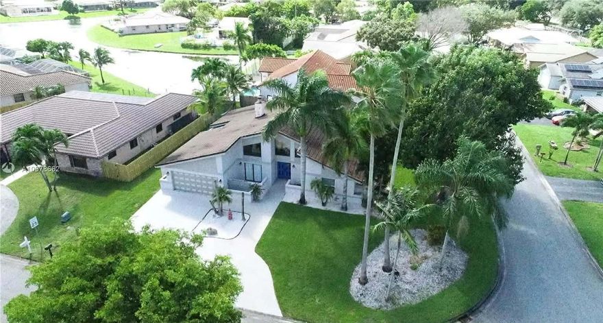 Remodeled corner-lot pool home featuring 4 bedrooms, 2 bathrooms, with the 4th bedroom created from a converted garage (can be converted back). Smart home upgrades include automated lighting, video doorbell, smart lock, and two Nest A/C thermostats. Updated kitchen with granite countertops, stainless steel appliances, snack bar, and island seating. Features include newer tile and carpet, recessed and LED lighting, and a cozy fireplace with reading area. Resort-style backyard with resurfaced heated lagoon pool & spa, beach patio, Tiki bar, outdoor theater screen, and speakers -- perfect for entertaining. Circular driveway, entrance waterfall, attic shelving, newer tankless water heater, and No HOA!