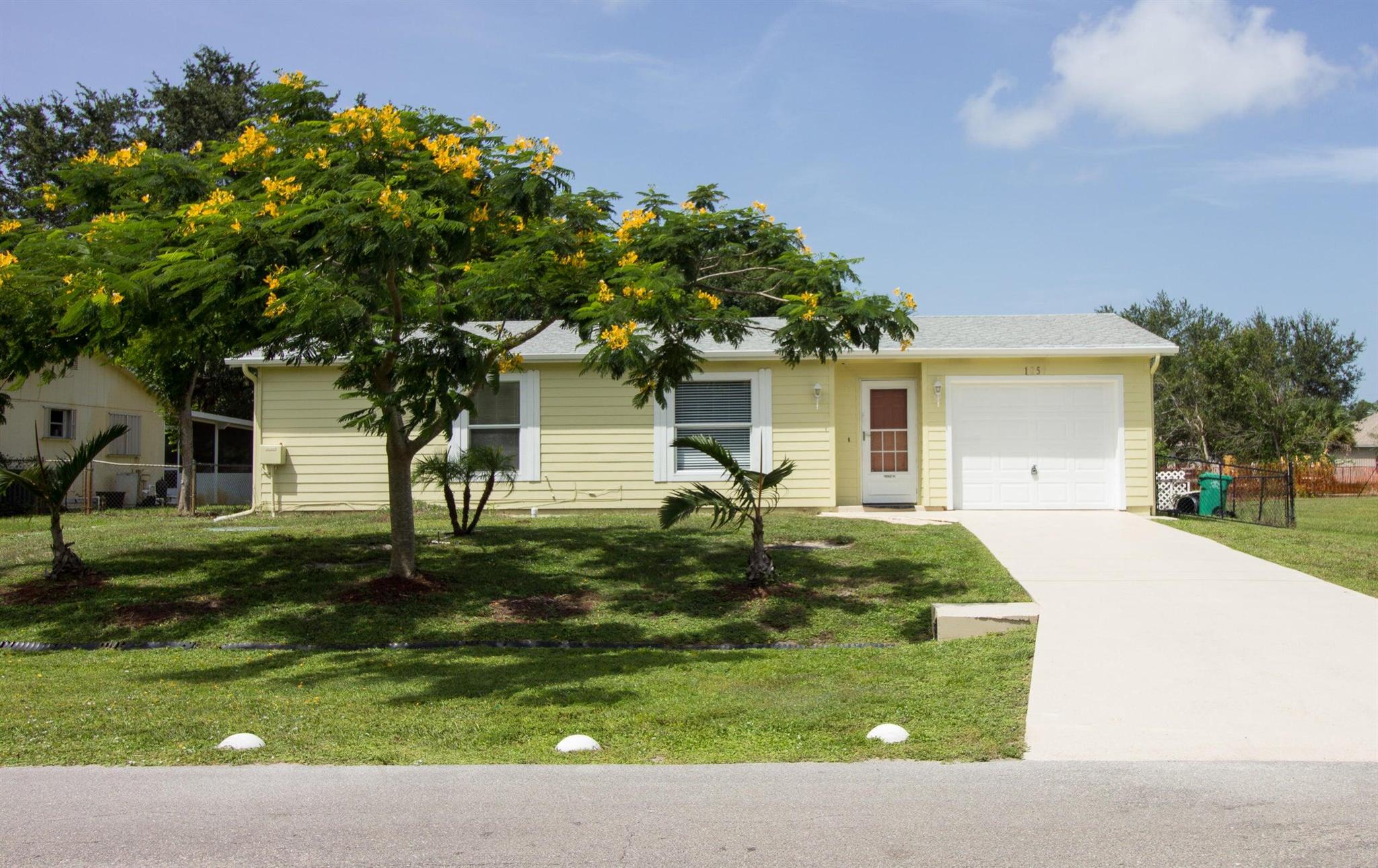Welcome to this beautifully maintained home in the heart of Port St. Lucie! This spacious property offers an open and inviting floor plan with plenty of natural light throughout. The kitchen features generous cabinet and counter space, making meal prep and gatherings a breeze. The primary suite includes a walk-in closet and en-suite bath for privacy and comfort. Step outside to a large backyard with mature mango trees--ideal for enjoying shade, fresh fruit, entertaining, gardening, or simply relaxing. Conveniently located near shopping, dining, schools, and major highways, this home provides both comfort and convenience. No HOA!
