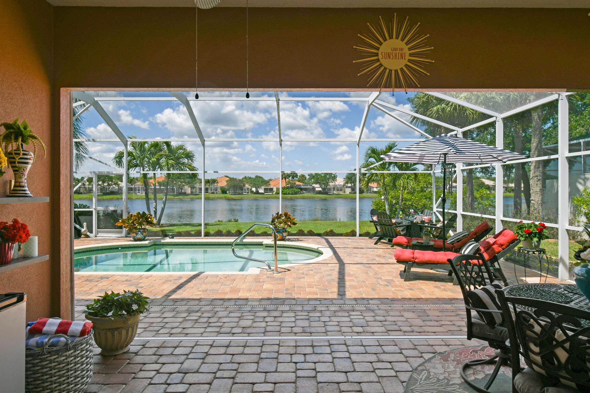Tucked away on a quiet street, In a Gated Enclave. This beautifully updated home offers stunning lake views and the perfect blend of tranquility and community living. Featuring 3 spacious bedrooms plus a flex room, this residence is designed for both comfort and functionality--ideal for unwinding in style. Step inside to an open-concept floor plan highlighted by stylish modern LVP flooring throughout, creating a warm, inviting atmosphere perfect for relaxing or entertaining. This modern style updated home is a must see.The screened patio offers a peaceful setting to enjoy your morning coffee or unwind poolside.