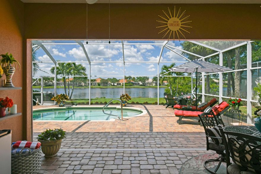 Tucked away on a quiet street, In a Gated Enclave. This beautifully updated home offers stunning lake views and the perfect blend of tranquility and community living. Featuring 3 spacious bedrooms plus a flex room, this residence is designed for both comfort and functionality--ideal for unwinding in style. Step inside to an open-concept floor plan highlighted by stylish modern LVP flooring throughout, creating a warm, inviting atmosphere perfect for relaxing or entertaining. This modern style updated home is a must see.The screened patio offers a peaceful setting to enjoy your morning coffee or unwind poolside.