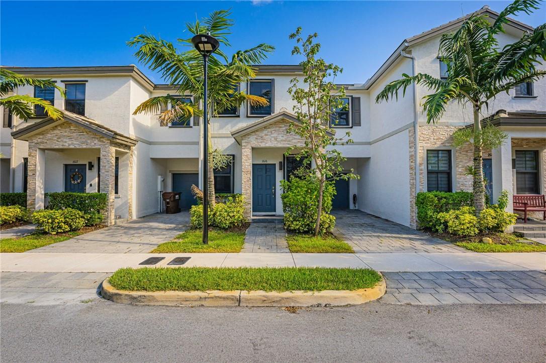 Welcome to The Edge on 15th! Built in 2020 in a beautiful gated community. This newer and modern townhouse features open kitchen with granite counter tops, subway tile backsplash, stainless steel appliances, and pantry! Modern tile floors throughout main living area. Great fenced in and pavered patio area! 1 car garage with a space in front of it for parking. Community pool and playground. Spacious primary bedroom features walk in closet and large bathroom with double sink vanity. Full size washer/Dryer upstairs! Perfectly located with easy access to major highways, Fort Lauderdale airport, shopping, dining, Las Olas, and beaches. Rent includes trash & front lawn maintenance.