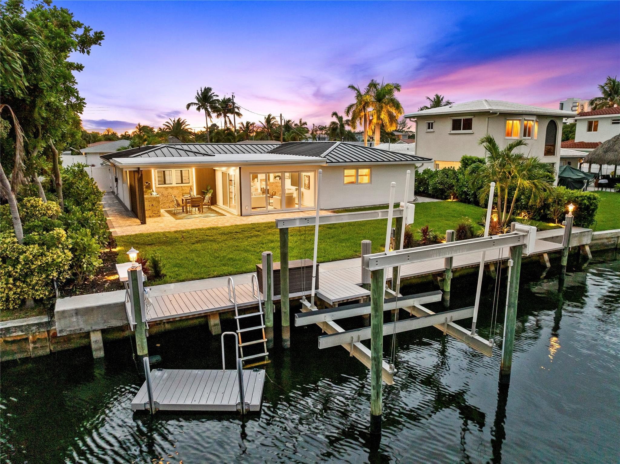 TOTALLY UPGRADED FROM TOP TO BOTTOM! OVER $400K IN UPDATES! Repriced To Sell! One-Of-A-Kind, Fully Renovated Waterfront Dream Home w/All Updates Fully Permitted By City Of Pompano Beach. 2025 Metal & Flat Roof (Rated To 218 mph) w/Warranties, Impact Windows, Luxury Wide-Plank Vinyl Flooring, Built-In Closets, LED Mirrors, & 9 Custom Waterfall-Edge Counters. Designer Kitchen w/Thermador Appliances, JennAir Fridge, & Miele Built-In Coffee Maker. Crystallo-Lit Mini Bar w/JennAir Wine Fridge. Outdoor Kitchen Includes Napoleon Grill & Blaze Fridge. Composite Dock, 12K Lb Boat Lift, Floating Dock, & Raised Seawall (2018). New Circular Driveway, Gutters, Epoxy Garage Floor, 7Ft Clusia Hedges, Retractable Screen, 4 Mini-Split A/Cs w/Individual Room Control. Full Centricon Termite.