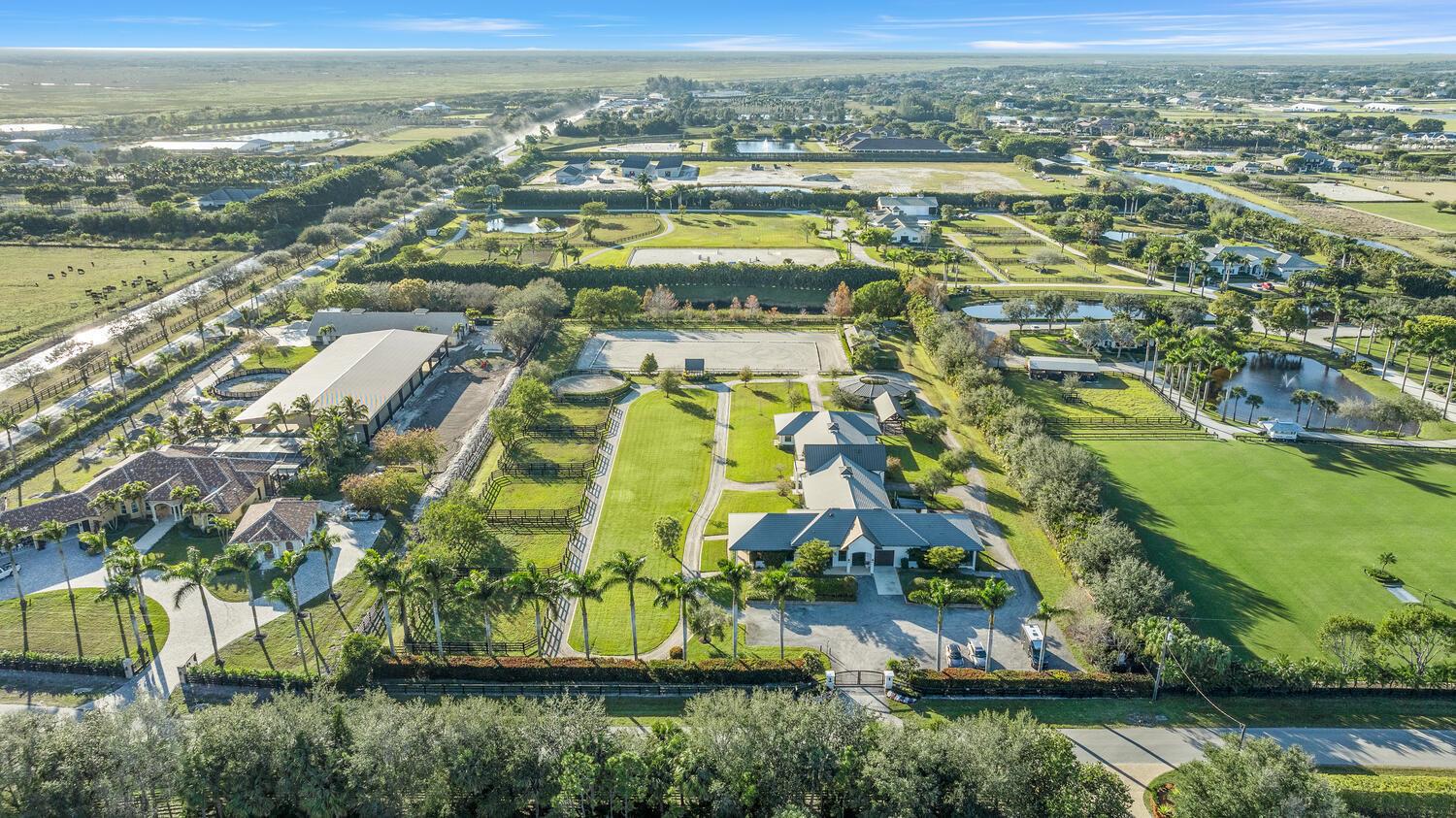 Location, Location, Location! This gated 5 acre 20 stall Stables Way equestrian oasis has it all. Located within hacking distance to the new show grounds and new entrance. The main barn has 16 stalls, tack room, riders lounge, laundry, feed & hay storage, 3 wash stalls, 5 grooming stalls, shutters and roll down doors. There is a luxurious owners quarters with porch and patio overlooking the property. There is also a 2 bedroom staff apartment and ample parking for cars, trucks and trailers.The fully irrigated arena is 130'X220' with a covered viewing area. There are 5 paddocks plus a 60' round pen. The 6 horse covered MK walker is adjacent to the main barn. Truly a MUST SEE property!