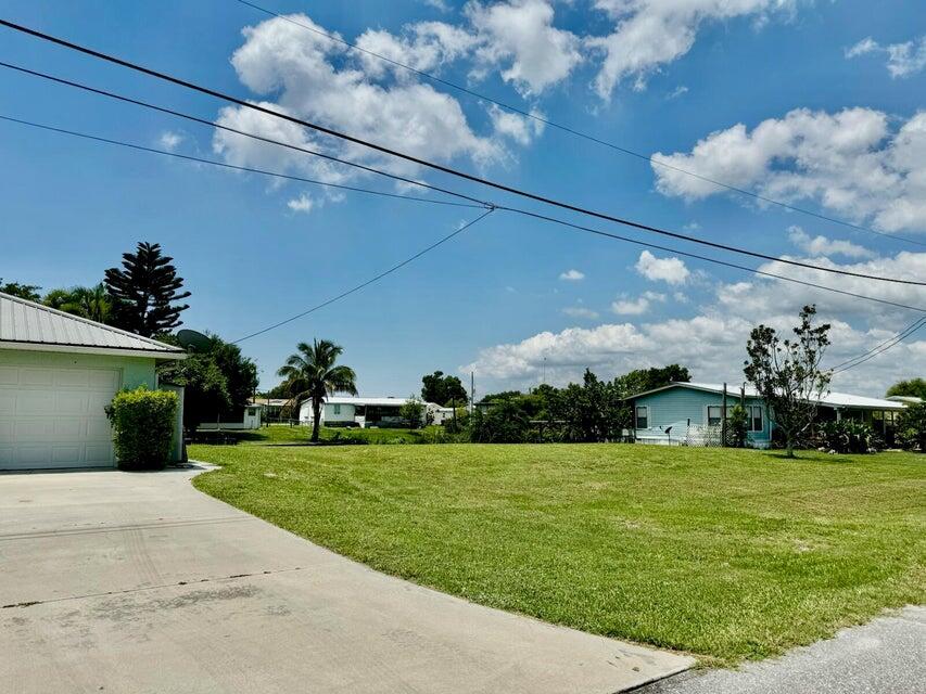 TAYLOR CREEK ISLES ~ Build your custom home on SE 31st St. Newer Seawall, fill dirt and sod completed. Fill dirt added to height of road. OR buy the 2007 home next door and Build your BIG GARAGE! Excellent location on canal Taylor Creek. Only minutes to the Lock! CAN YOU HEAR THE FISH BITING?