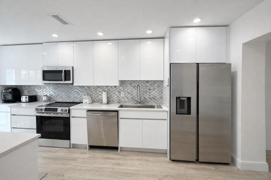 Stunning remodeled modern, spacious, and bright two-story condo with beautiful lake views in the sought-after Hunters Run Country Club. Live the Florida dream in this gorgeous home featuring quartz countertops, stainless steel appliances, and modern flooring throughout. Enjoy unsurpassed amenities through the club, including golf, tennis, pickle ball, restaurants, fitness center, and social events. Conveniently located near beaches, shopping, and dining. A must-see!