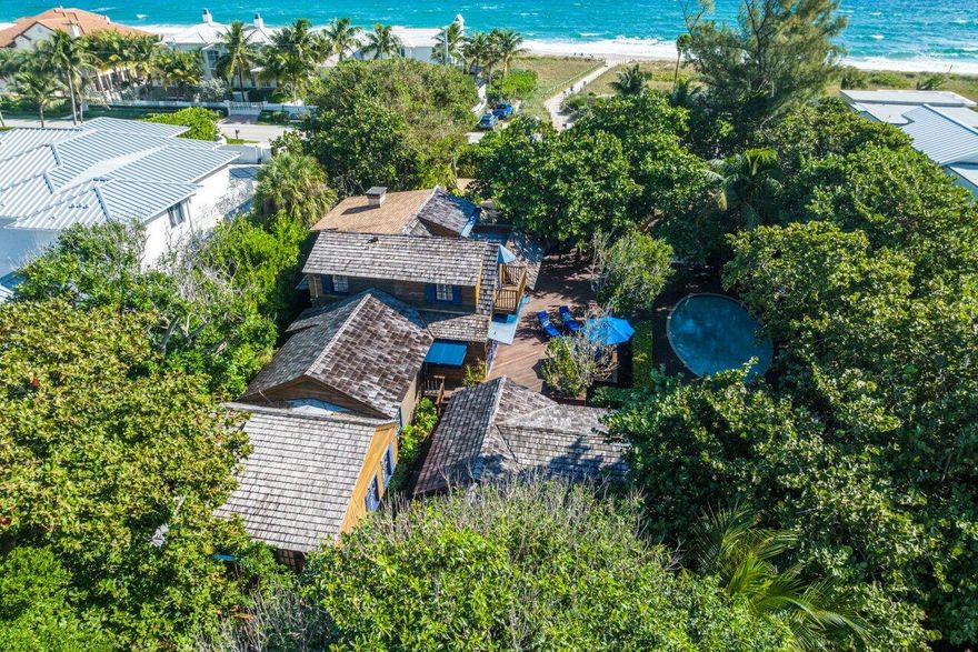 ''Ocean Apple.'' Historic. Iconic. Oceanfront living where Delray Beach-meets-The Hamptons. A timeless John Volk-designed 1935 beachfront compound whose time has come. Picturesque ocean vistas with the elegantly-weathered warmth and charm of a classic seaside retreat. A .62-acre oasis away from the world in a premier location for beach & town. 

Whether renovating, expanding, reimagining, or simply just moving in - a coveted coastal opportunity awaits. The Grounds and Residence

Listed on the local Historic Register and featured in numerous architectural publications, the captivating oceanfront compound presides over a rare 100' wide tropical enclave of 2/3 acre of lush Florida varietals. Massive mature gumbo-limbo trees, 100+ year-old sea grape trees, various palm tree species and oversized rubber trees enhance this untamed, private oasis. Underneath this verdant canopy, the property boasts an expanse of authentic tropical hardwood decks and terraces, sparkling swimming pool, sunken spa, exercise sauna and inviting walking paths.

Warmly woven with vintage South Florida charm and Northeastern shake shingle architecture, Ocean Apple features a main house and guest cottage spanning over 5,400 square feet and 6 bedrooms, 6.1 baths with separate "treehouse" office/sleeping quarters, 2-car garage and storage structure.

The innate beauty of the compound is found across both the interiors and outdoor spaces of the home. Ocean Apple is adorned with warm cypress ceilings and walls, original Dade County pine flooring, French doors and abundant windows for endless natural light. The well-appointed living and dining areas elegantly unfold to breezy verandahs, rich wooden decks, the swimming oasis and serene tropical gardens, while the master bedroom suite commands expansive ocean vistas and breath-taking views of the sunrise.

Ocean Apple presents its next generation of owners with endless possibilities and welcome a freshly-inspired coastal compound. Whether renovating, expanding or reimagining the existing main house and surrounding habitats while preserving the estate's unique historic charm, this coveted opportunity awaits to make this exceptional property your very own vision of the "Hamptons-meets-Delray Beach" lifestyle