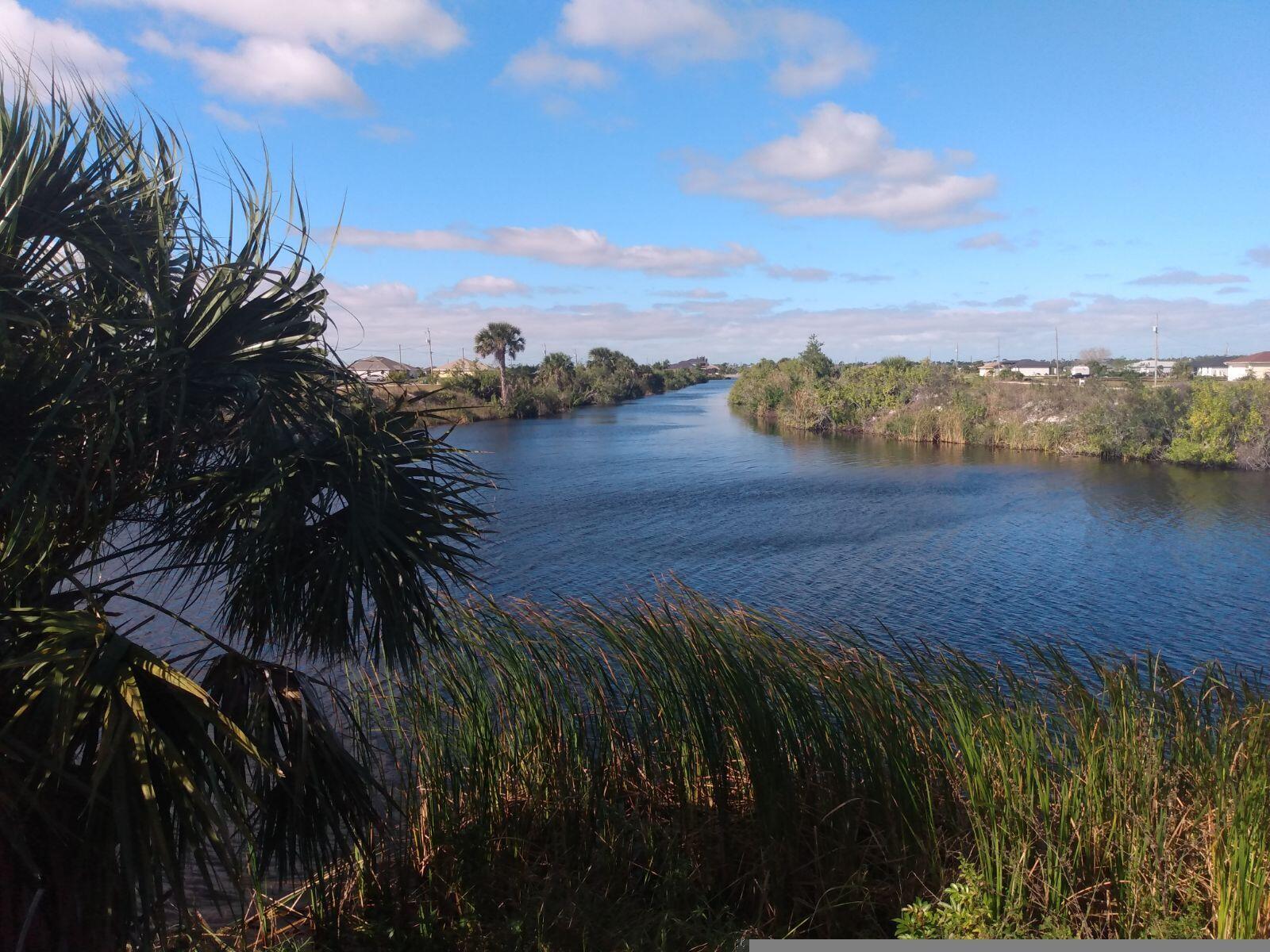 Hot! Don't miss this opportunity in the up and coming Northwest area of Cape Coral. West of Burnt Store Road surrounded by a community of lovely homes. Western rear exposure offers beautiful sunsets. Directly on intersection with stunning view of wide canal ''crossroads'' perfect for an infinity pool which would allow for appearance of water flowing right up to your custom home.
