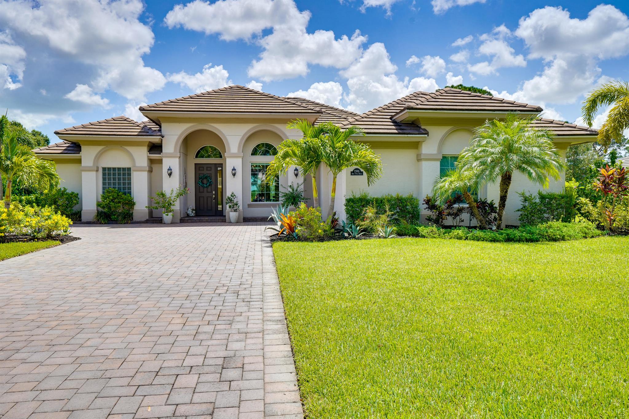 Stunning 3 bedroom, 3 bathroom GHO built pool home in the desirable Meadowood community. Designer style screened-in saltwater and heated pool with bench seating and jets. The home features an open main living area and split bedroom floor plan. Kitchen features quartz counter tops, subway tile backsplash, crown molding on the cabinets, a center island and breakfast nook overlooking the pool. Separate dining room with volume ceilings and archway details. The guest bedrooms feature crown molding and plantation shutters. Primary bedroom retreat is located on its own side of the home. The large bedroom features a tray ceiling, plantation shutters and a door to the back patio and pool area.