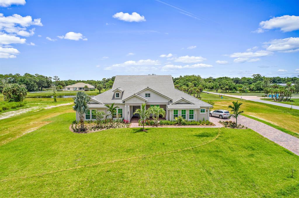 Built 2020 this spacious one story sits on 1.65 acres, enjoy tranquil scenic water views, entertaining on extended lanai overlooking heated salt water pool/spa & extensive lawn. Split floor plan features high ceilings, expansive master suite, notable large closet, master bathroom with upgraded cabinetry. Chef's kitchen includes stainless steel appliances, gas stove, quartz counter tops with 13-foot waterfall island. Generation/in-law suite complete with dishwasher, refrigerator, sink & microwave. Impact glass throughout. 1000-gallon propane tank, circulating hot water, generator ready with stub out & pad, plumbed for summer kitchen. Garage has epoxy floors, Reynolds Ranch has beautiful lakes, private equestrian/walking paths & day paddock for residents' horses!