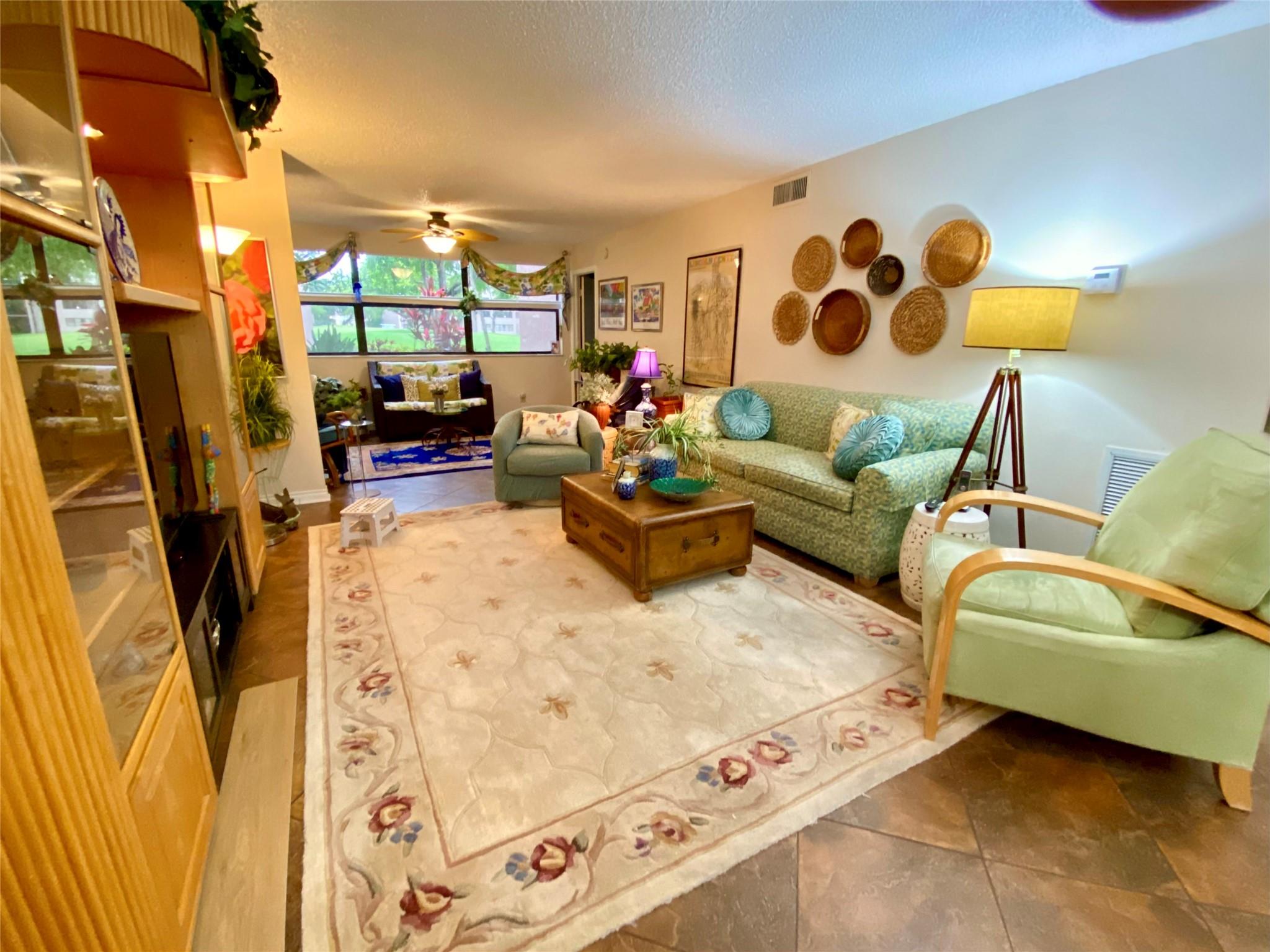 This 1st floor inside corner condo has an assigned parking spot at the front door. It offers golf and water views. The building has a one-year-old roof, a just upgraded elevator, and is within steps to a satellite pool. The community offers a clubhouse with non-stop activities, a theater, ballroom for parties, free gym, exercise classes, golf, tennis pool parties, a BBQ's to cook your own food, and much more. At least one owner age requirement is 55+ per condo association. Must meet condo assoc. financial requirements.